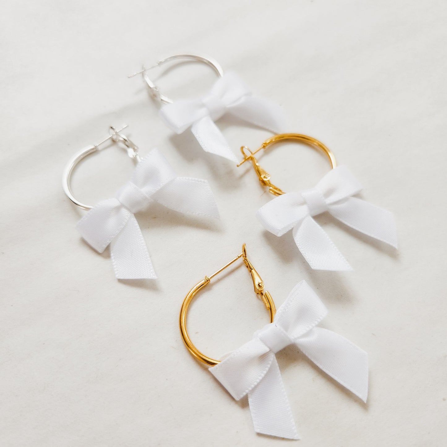 Mini Bow Hoop Earrings available with gold or silver details
